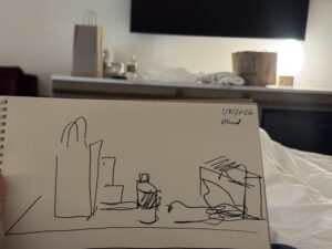 Blind sketch of some stuff on a shelf in a hotel